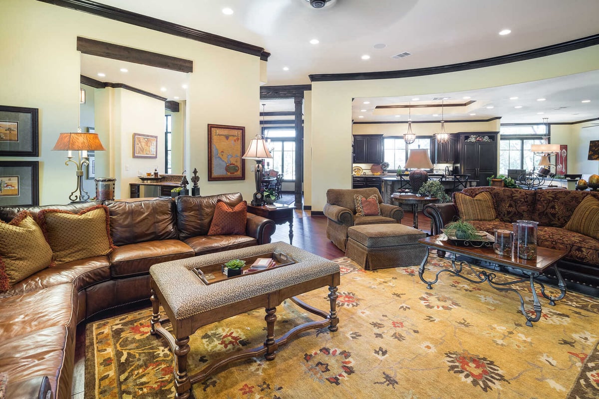 Living room with leather furniture in a custom home by J Bryant Boyd in Georgetown, TX