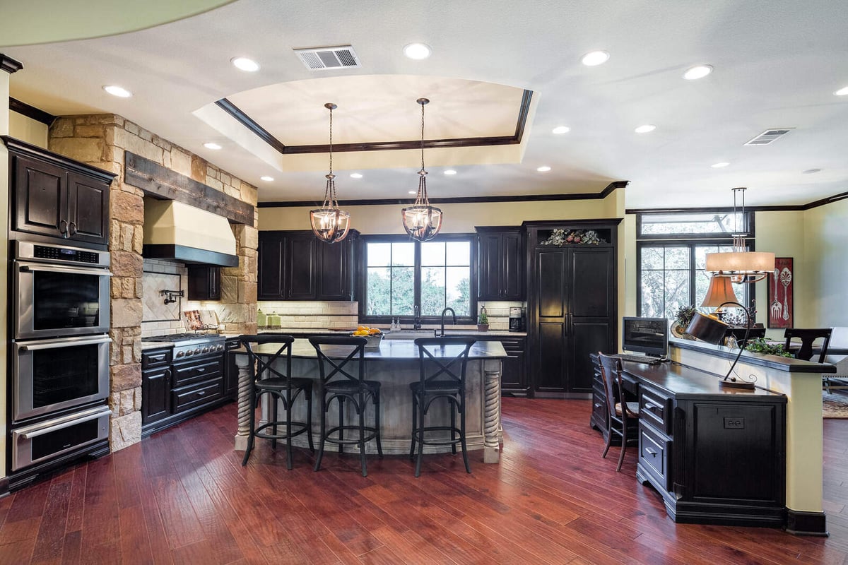 Luxurious custom kitchen with island and stone features by J Bryant Boyd in Georgetown, TX