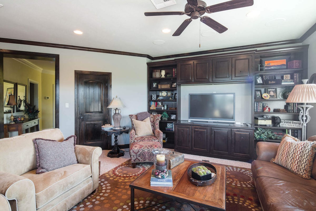 Media room with built-in entertainment center in a custom home by J Bryant Boyd in Georgetown, TX