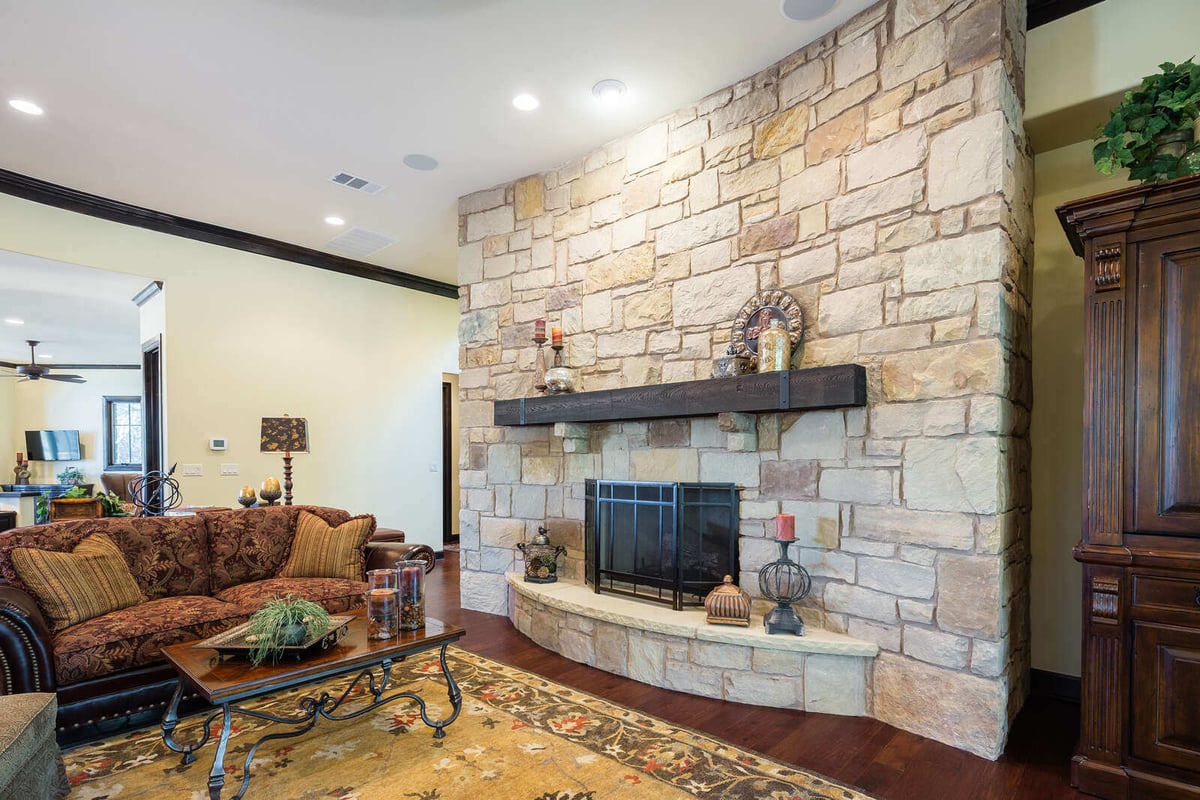 Stone fireplace in a custom home living room by J Bryant Boyd in Georgetown, TX