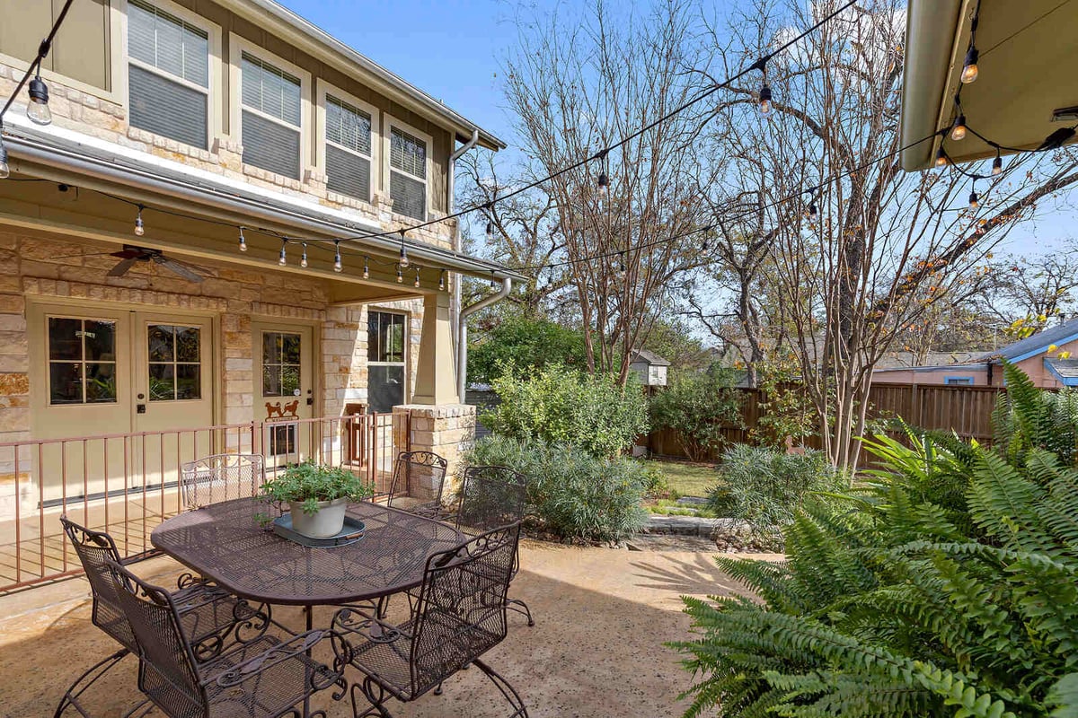 Backyard patio with string lights and outdoor dining set, custom home by J Bryant Boyd in Georgetown, TX