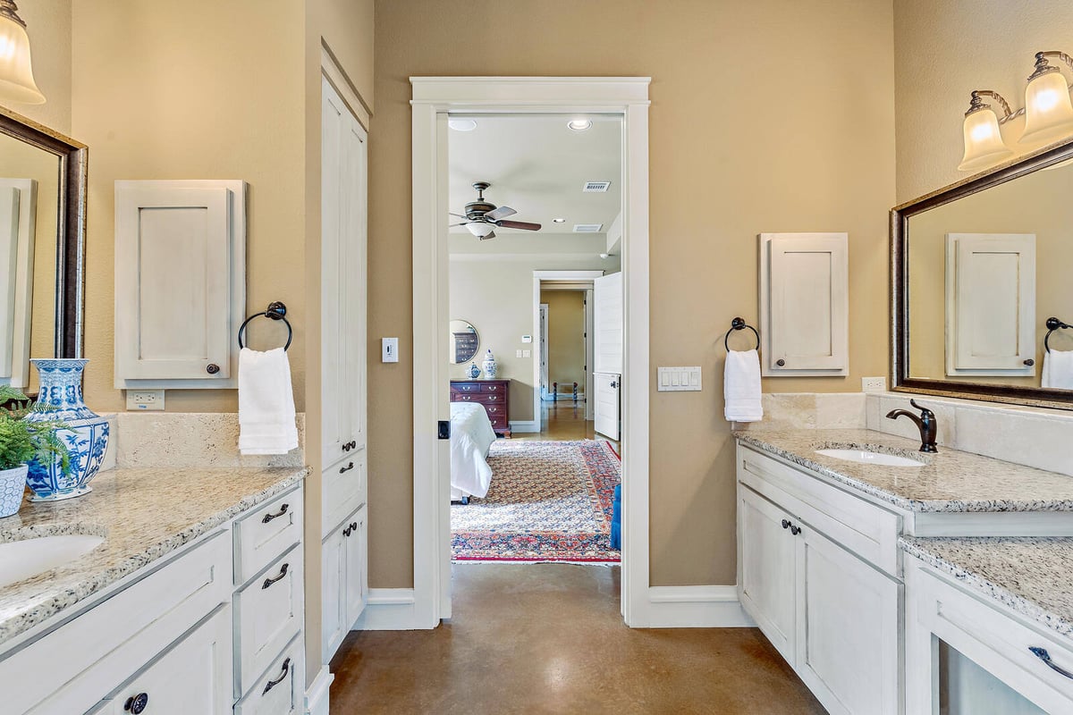 Bathroom with scenic window view and deep soaking tub in a custom home by J Bryant Boyd in Georgetown, TX