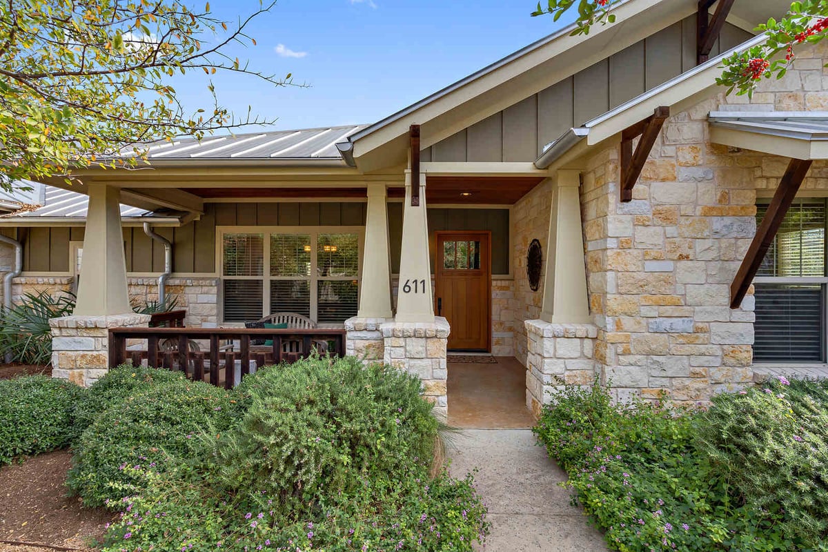 Covered patio area with stone accents and outdoor seating, custom home by J Bryant Boyd in Georgetown, TX