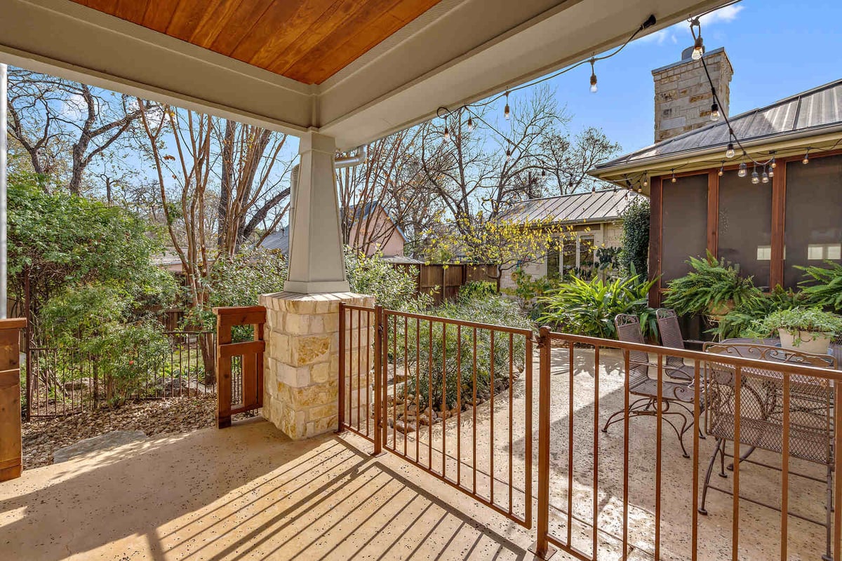 Covered patio area with string lights and outdoor seating in a custom Georgetown, TX home by J Bryant Boyd