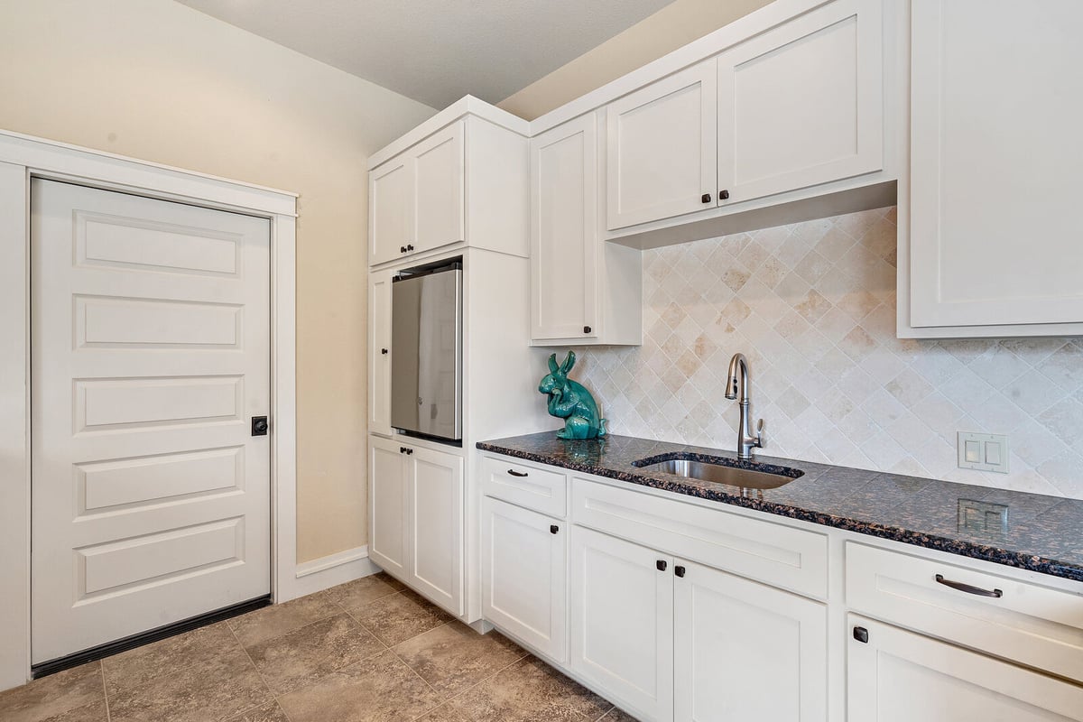 Cozy kitchen with an island and decorative lighting, custom home by J Bryant Boyd in Georgetown, TX