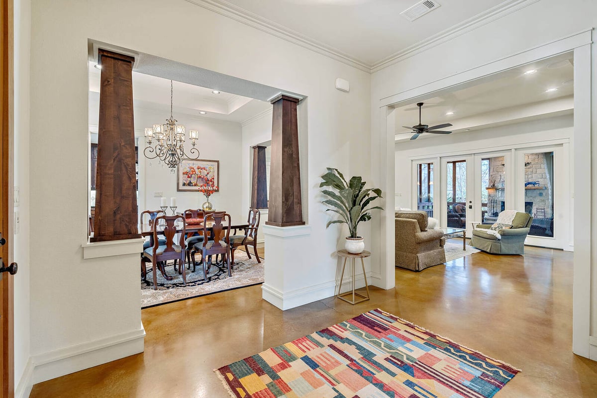 Dining area and living room with high ceilings in a custom home by J Bryant Boyd in Georgetown, TX