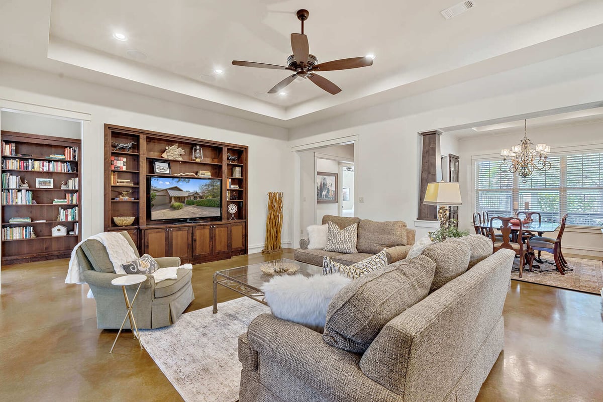 Dining room with view into the kitchen and living areas in a custom home by J Bryant Boyd in Georgetown, TX