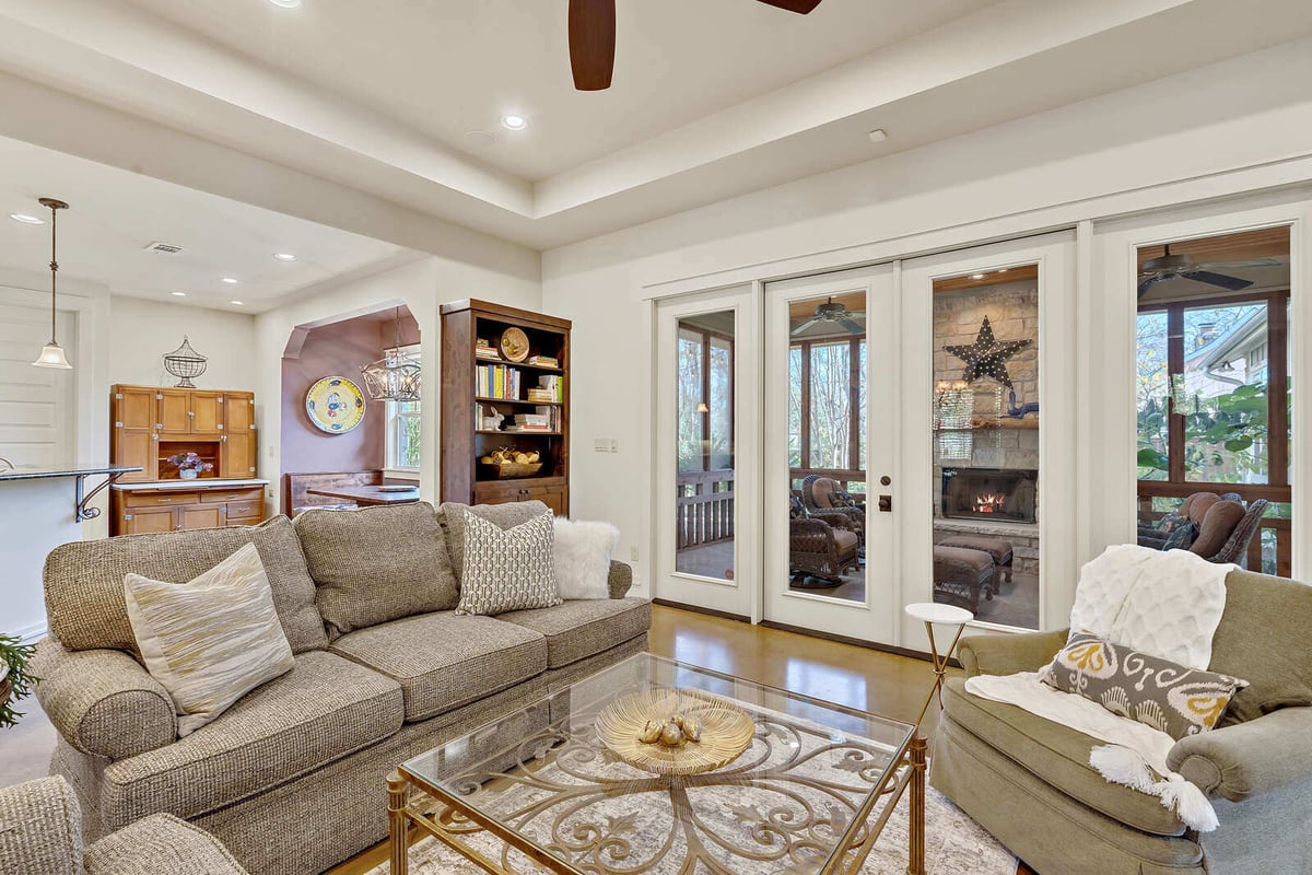 Elegant dining room with chandelier and large windows in a custom home by J Bryant Boyd in Georgetown, TX