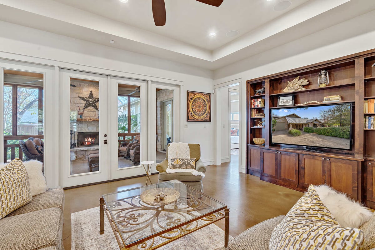 Formal dining room with wood table and decorative chandelier in a custom home by J Bryant Boyd in Georgetown, TX