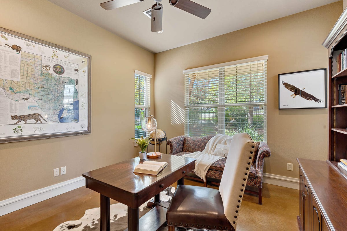 Home office with large windows and natural light in a custom home by J Bryant Boyd in Georgetown, TX