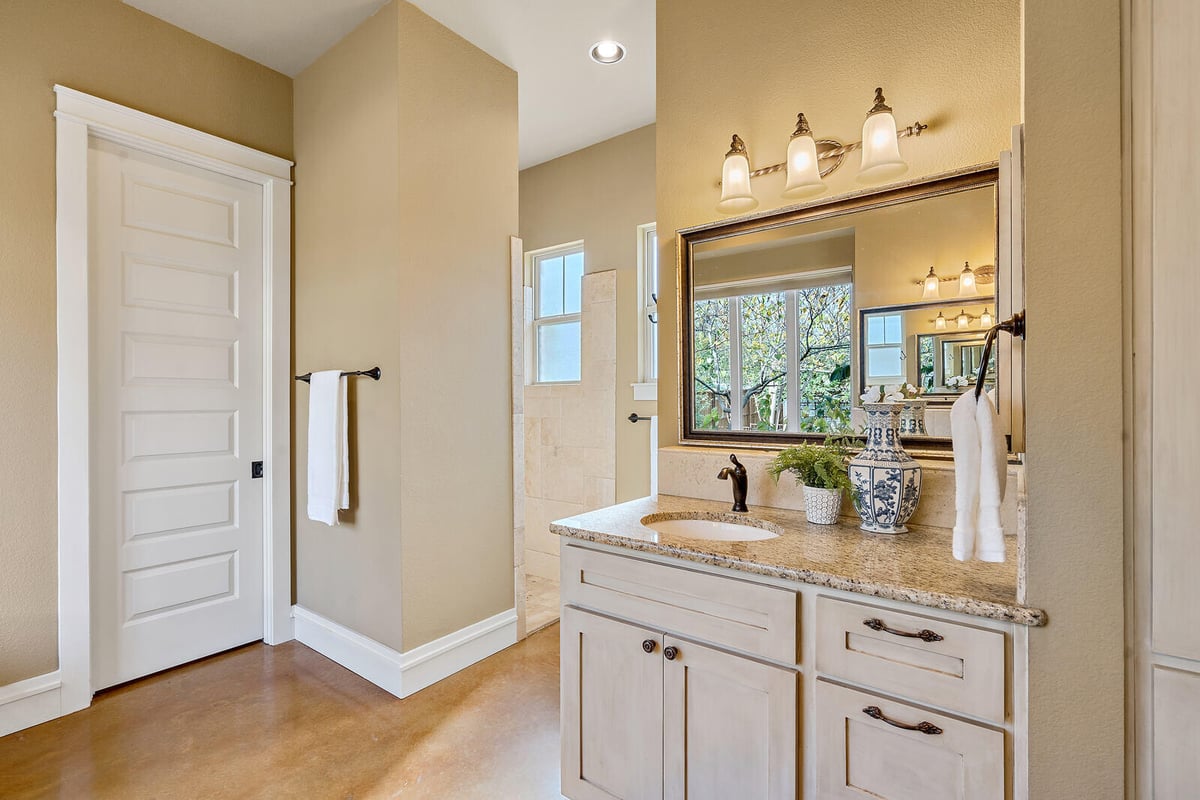 Master bedroom view from the en-suite bathroom, showcasing custom cabinetry by J Bryant Boyd in Georgetown, TX