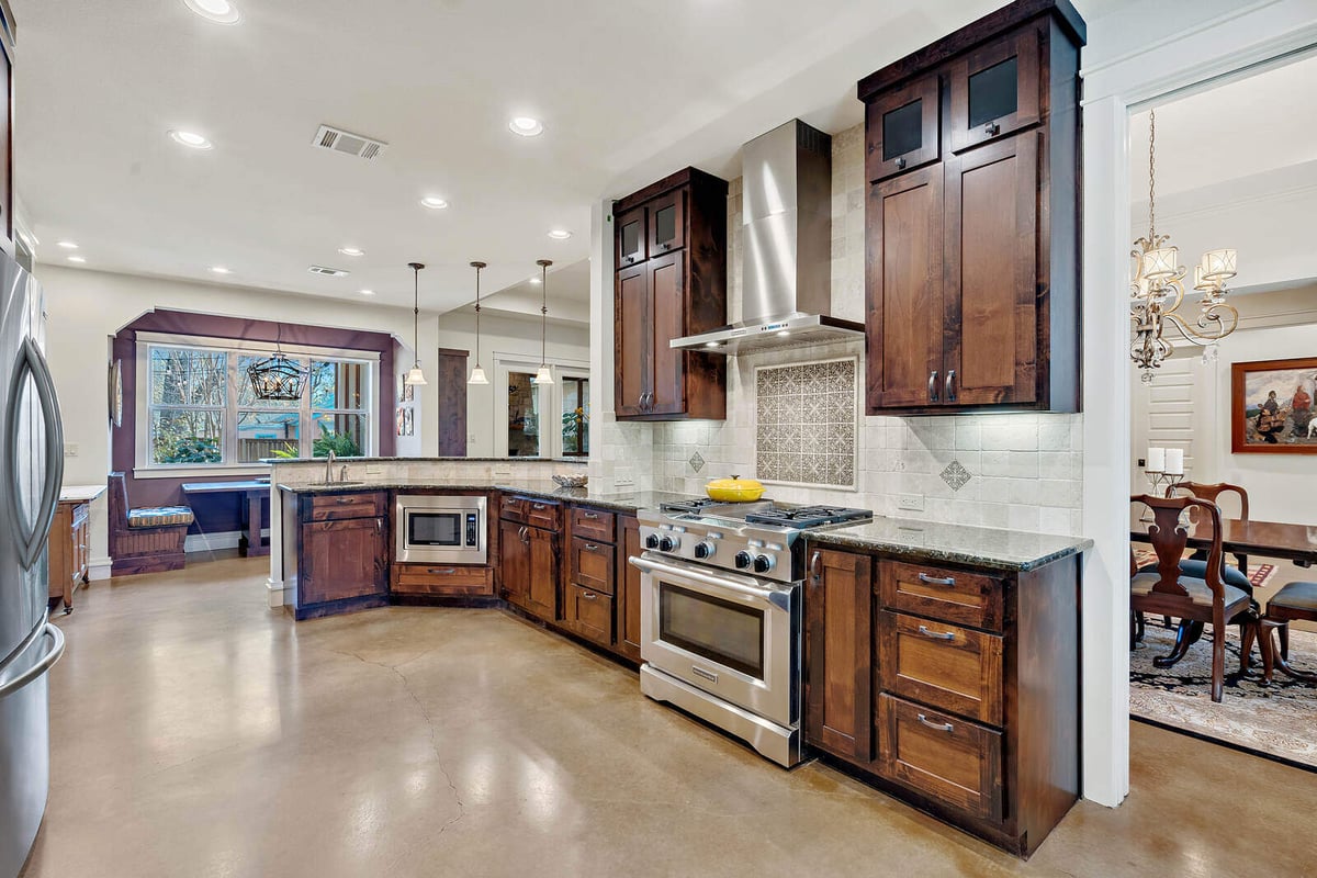 Modern kitchen with granite countertops and stainless steel range in a custom home by J Bryant Boyd, Georgetown, TX