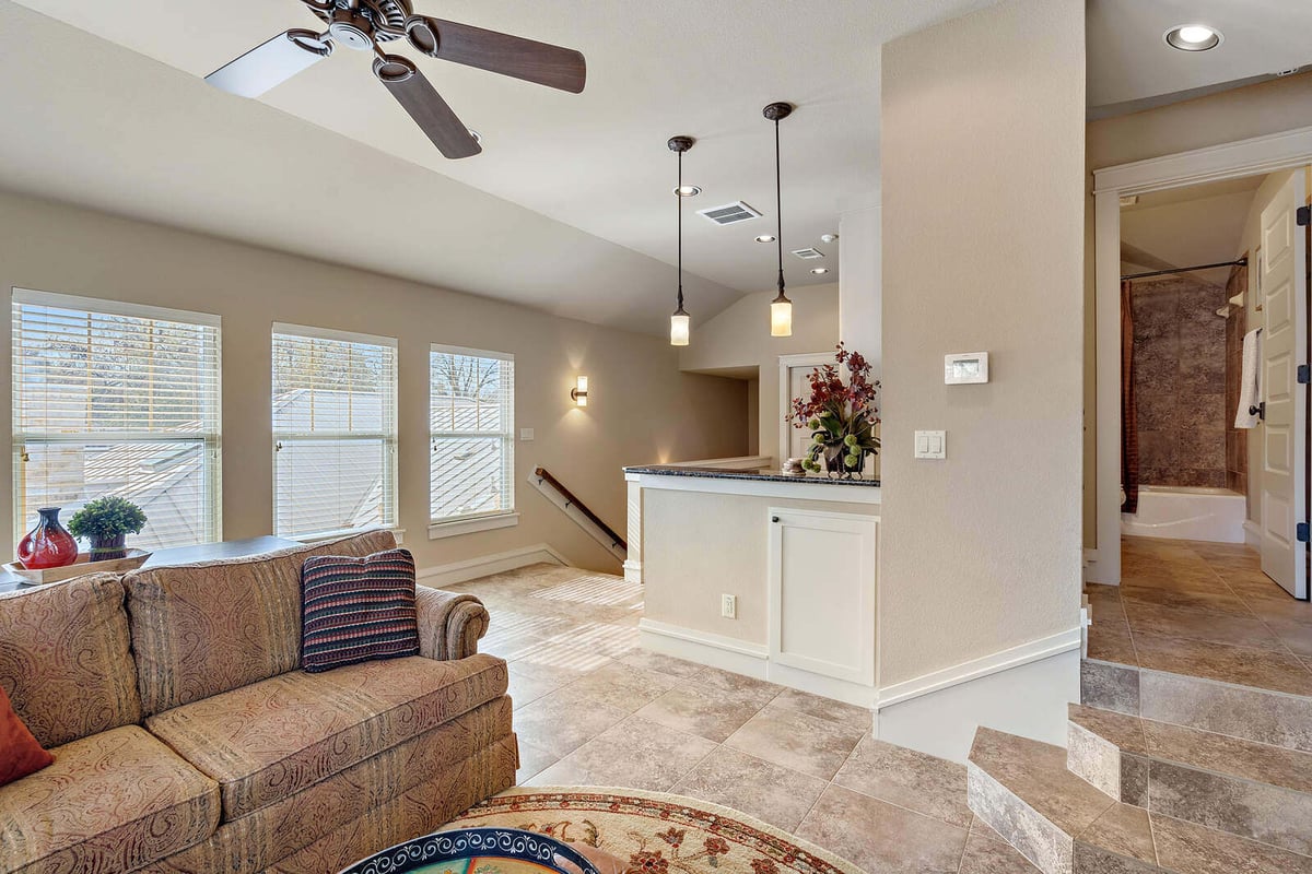 Open-concept kitchen and living area with white cabinetry, custom home by J Bryant Boyd in Georgetown, TX