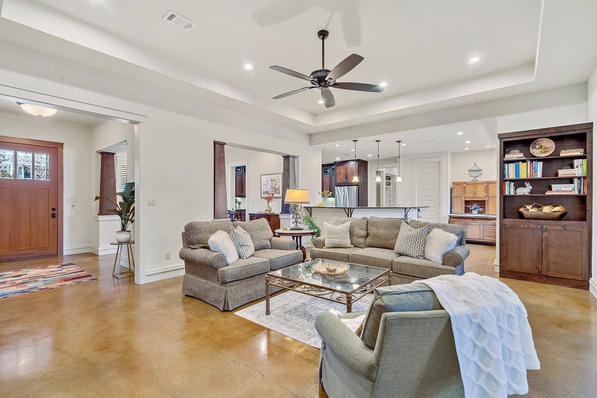 Open-concept living room and kitchen area in a custom home by J Bryant Boyd in Georgetown, TX