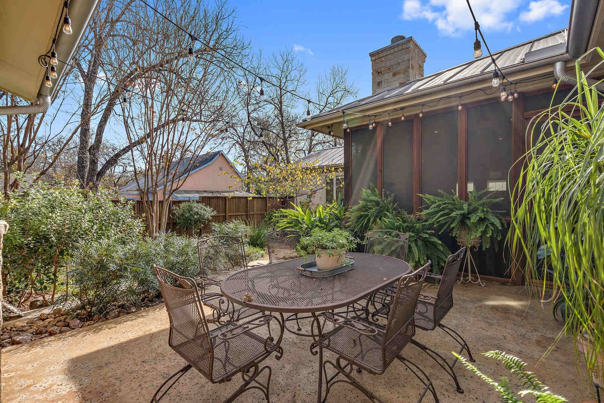 Outdoor patio with string lights and potted plants in a Georgetown, TX custom home by J Bryant Boyd