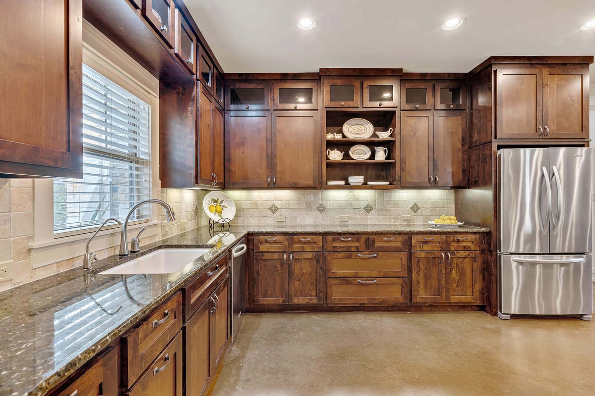 Rustic kitchen cabinetry with stainless steel appliances in a custom home by J Bryant Boyd, Georgetown, TX