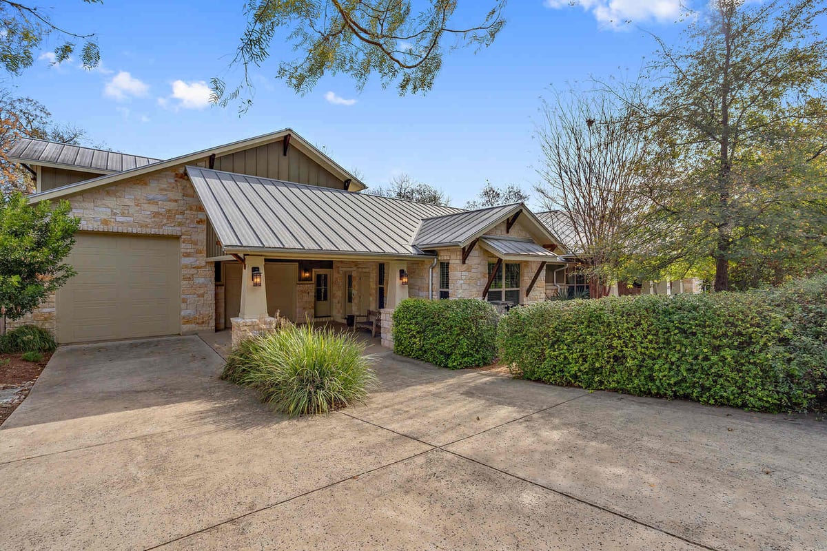 Well-maintained garden path leading to a custom home by J Bryant Boyd in Georgetown, TX