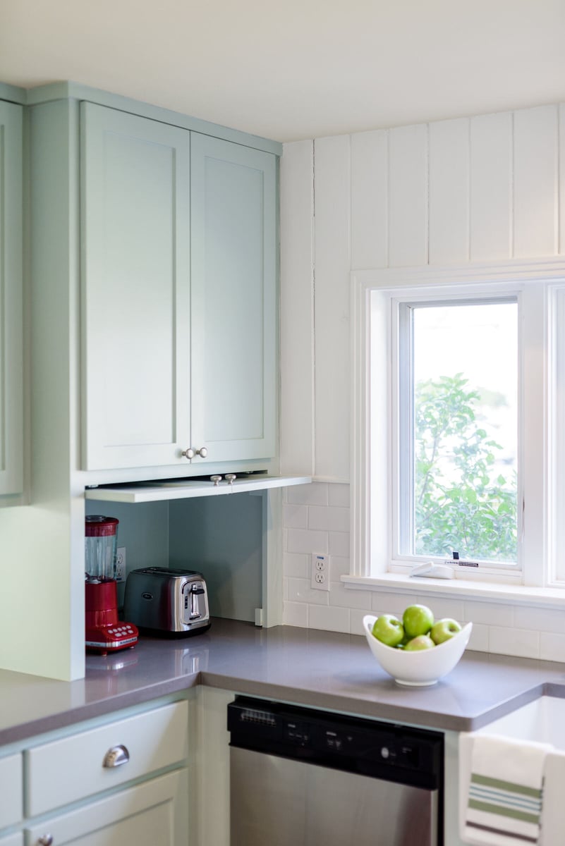 Kitchen corner with light blue cabinets and modern appliances in a Georgetown, TX remodel by J Bryant Boyd