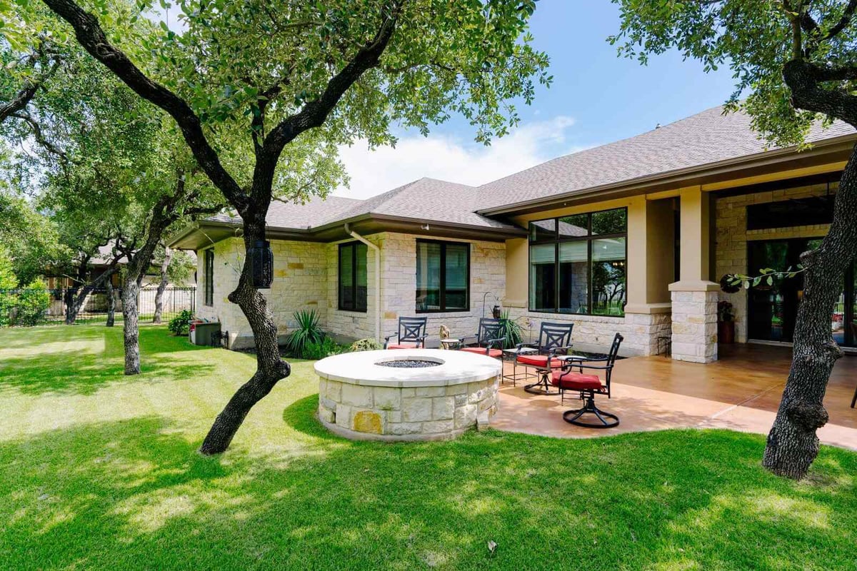 Backyard patio with seating area in a custom home by J Bryant Boyd, Georgetown, Texas