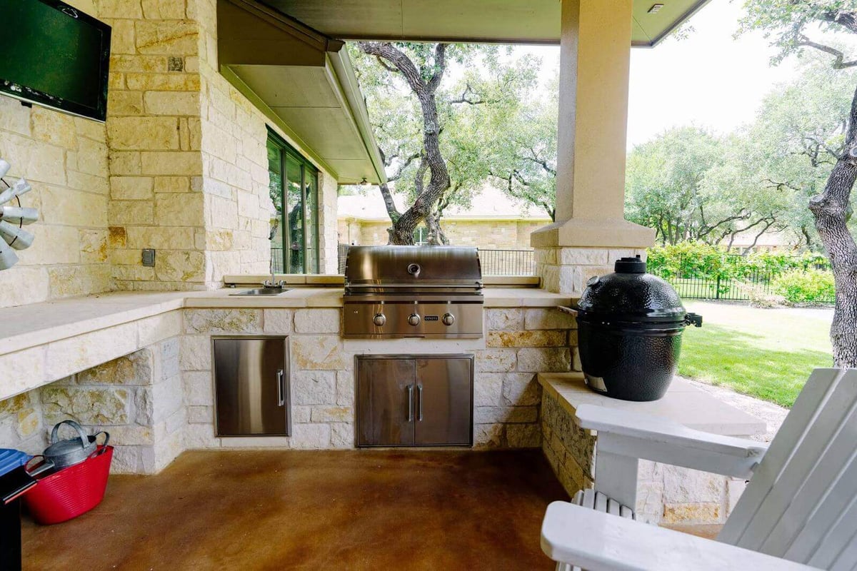 Outdoor kitchen with grill in a custom home by J Bryant Boyd, Georgetown, Texas