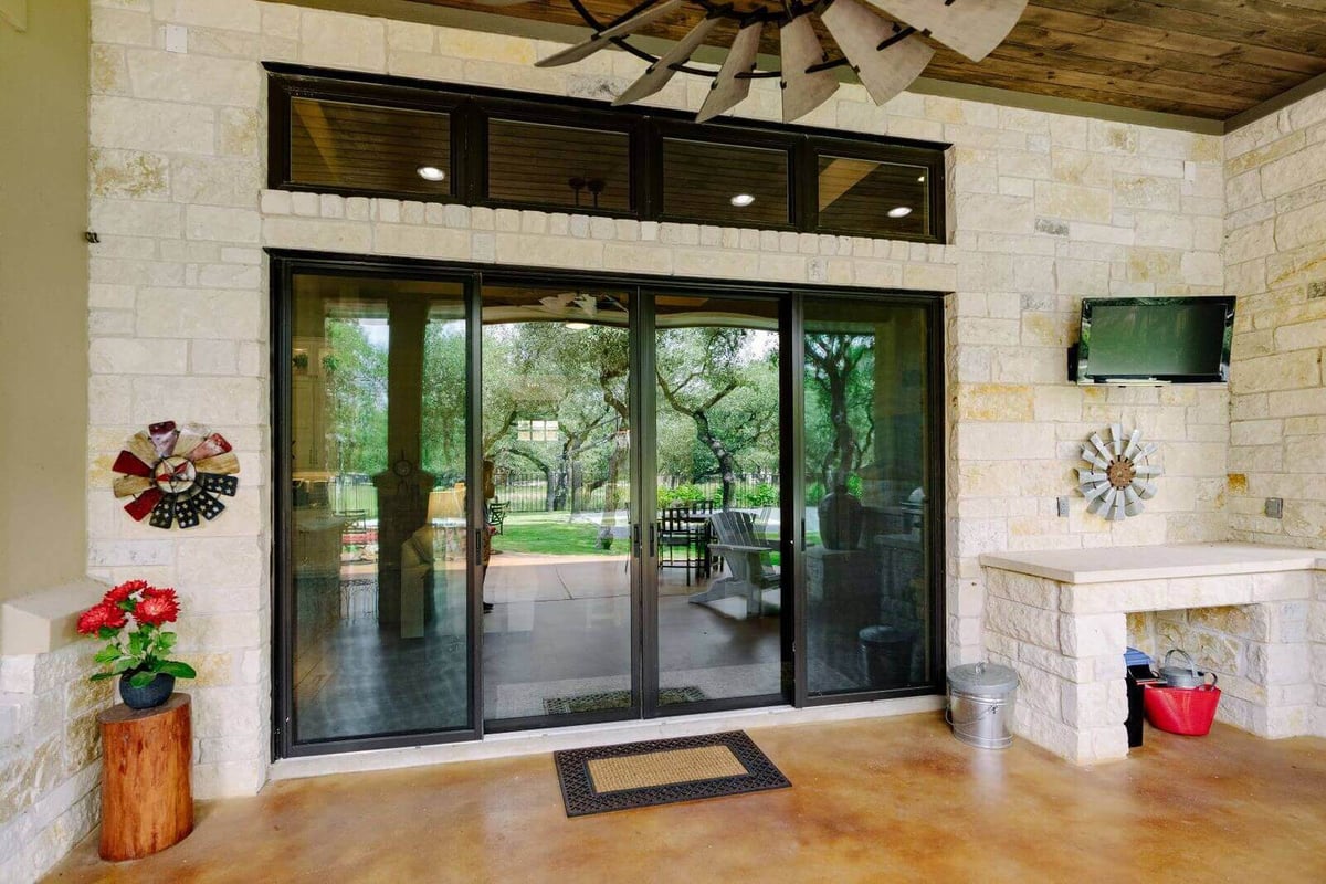 Patio with sliding glass doors in a custom home by J Bryant Boyd, Georgetown, Texas