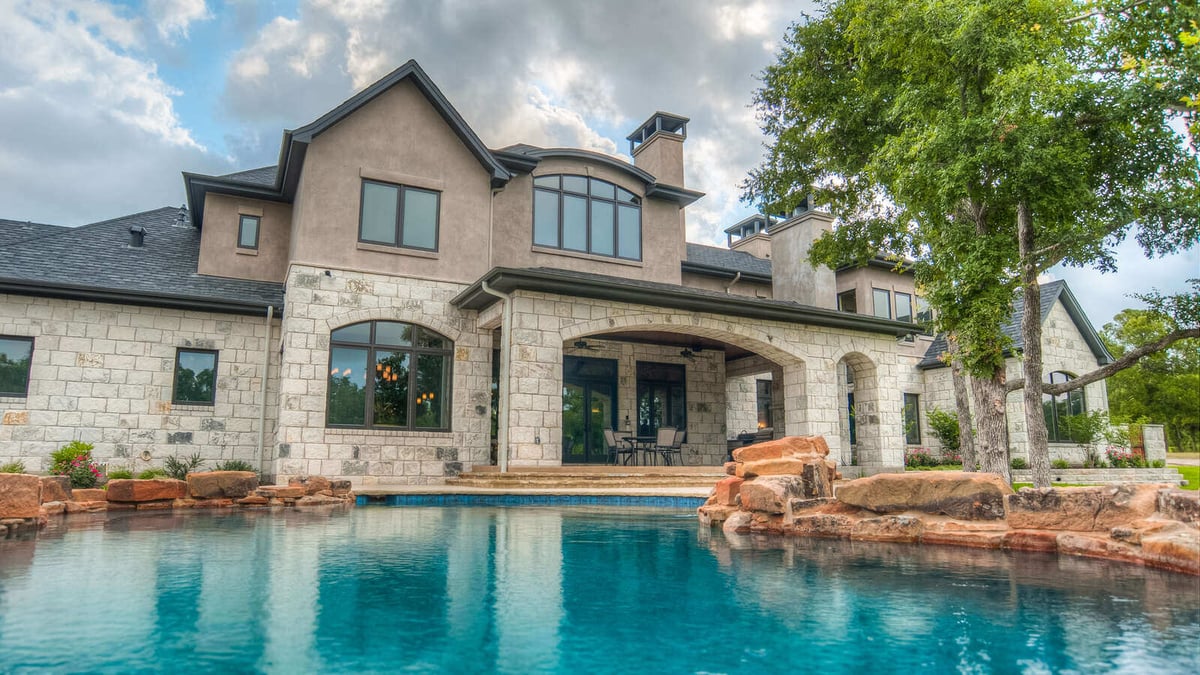 Backyard view of a Georgetown, TX custom home with a large pool, built by J Bryant Boyd