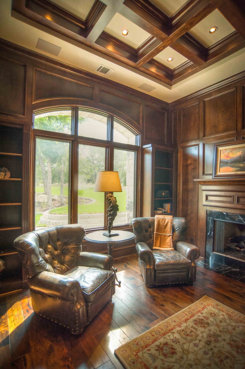 Cozy study with rich wood paneling and large window in a custom home by J Bryant Boyd in Georgetown, TX-1