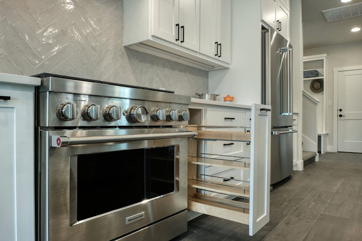 Detailed view of kitchen cabinetry with pull-out shelves by J Bryant Boyd in Georgetown, Texas