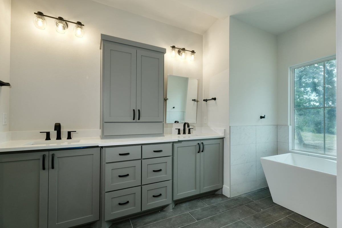 Modern bathroom with white vanity and black accents by J Bryant Boyd in Georgetown, Texas