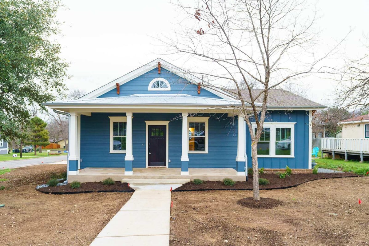 Blue custom home exterior with front porch in Georgetown, Texas, by J Bryant Boyd