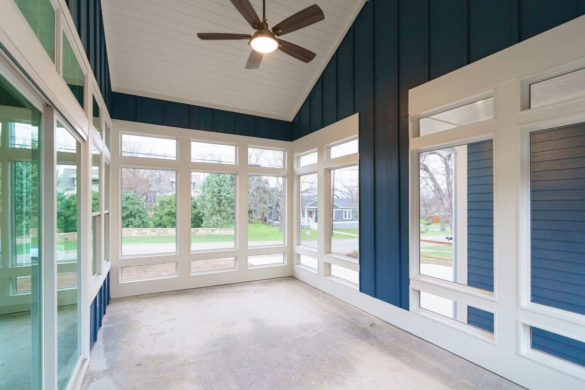 Bright sunroom with large windows in a custom home by J Bryant Boyd in Georgetown, Texas