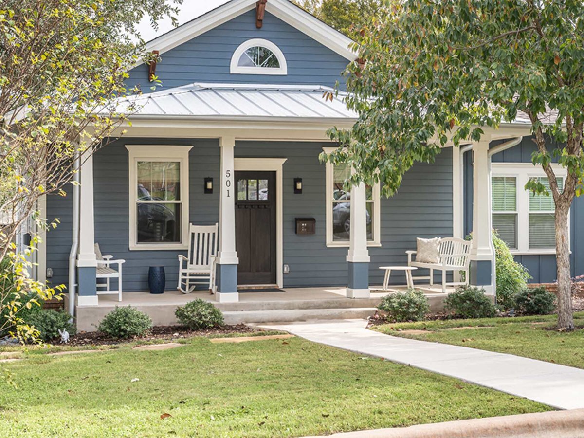 Custom blue home exterior with white trim in Georgetown, Texas, by J Bryant Boyd