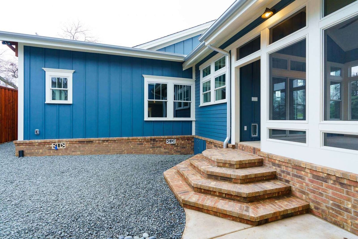 Custom home exterior with blue siding and large windows in Georgetown, Texas, by J Bryant Boyd