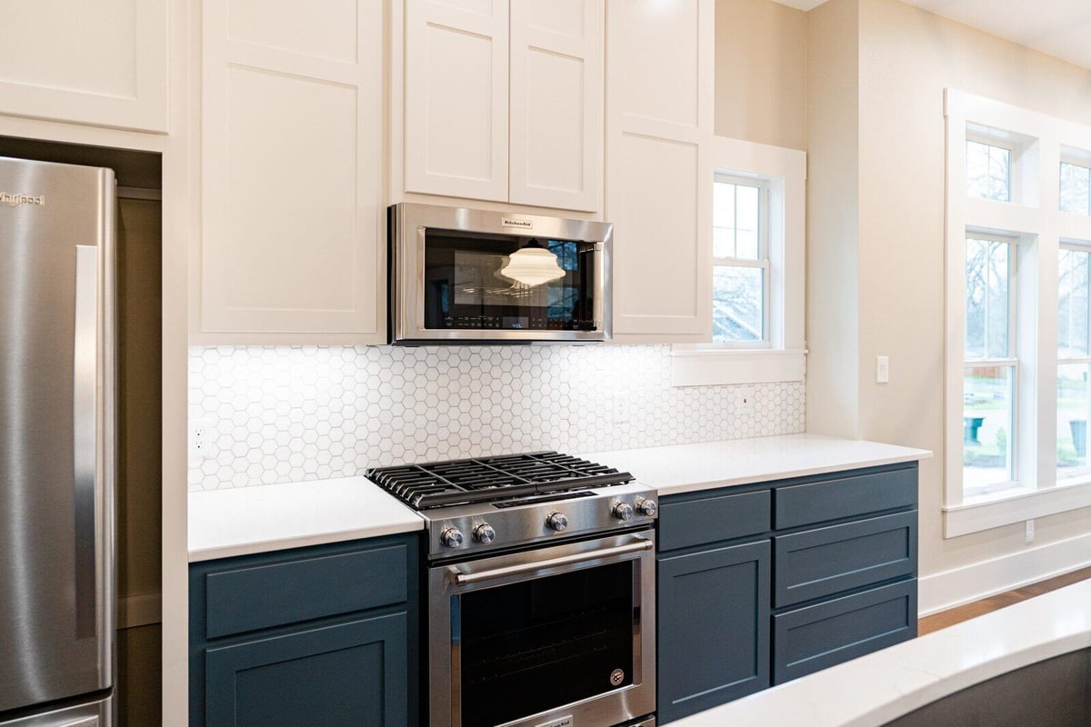 Modern kitchen with white and blue cabinets in Georgetown, Texas, by J Bryant Boyd
