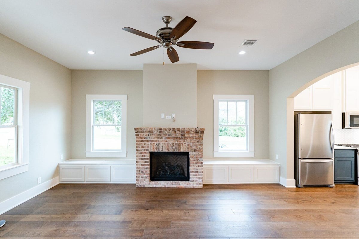 Modern living room with brick fireplace in a custom home in Georgetown, Texas, by J Bryant Boyd