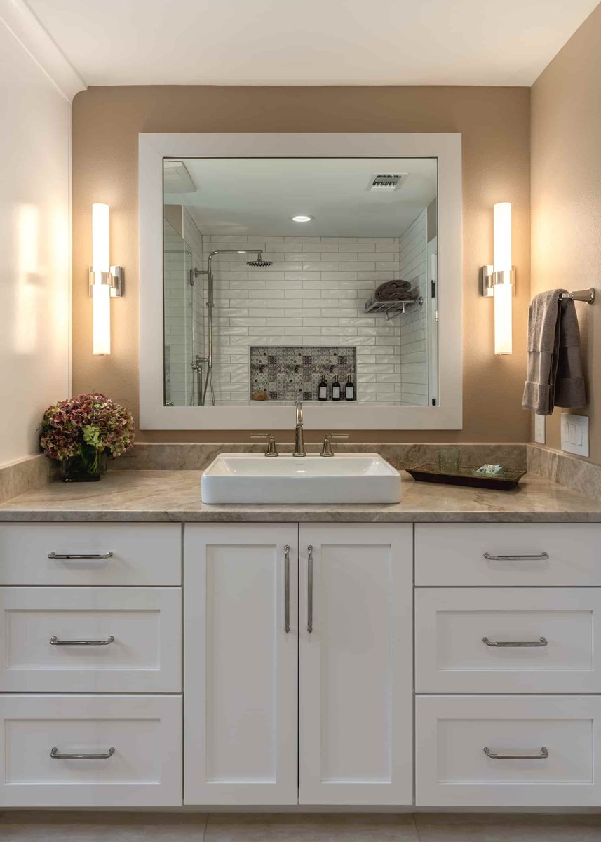 Modern Texas bathroom with a prominent mirror and sink, designed by J Bryant Boyd.
