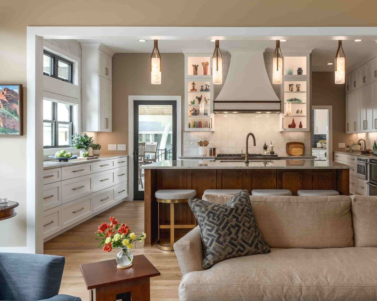 A Texas kitchen and living room designed by J Bryant Boyd, showcasing a welcoming couch and an elegant coffee table.