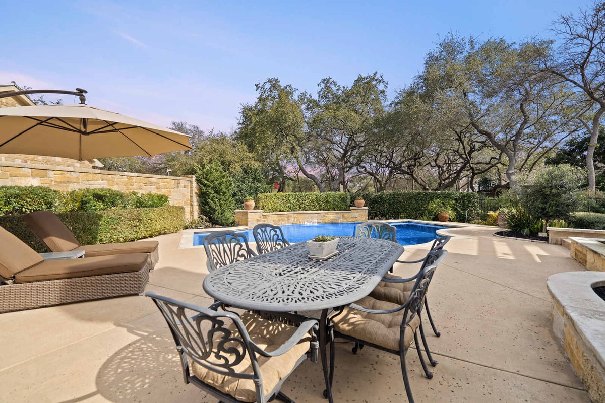 Backyard view of pool and dining area in a custom home by J Bryant Boyd, Georgetown, TX