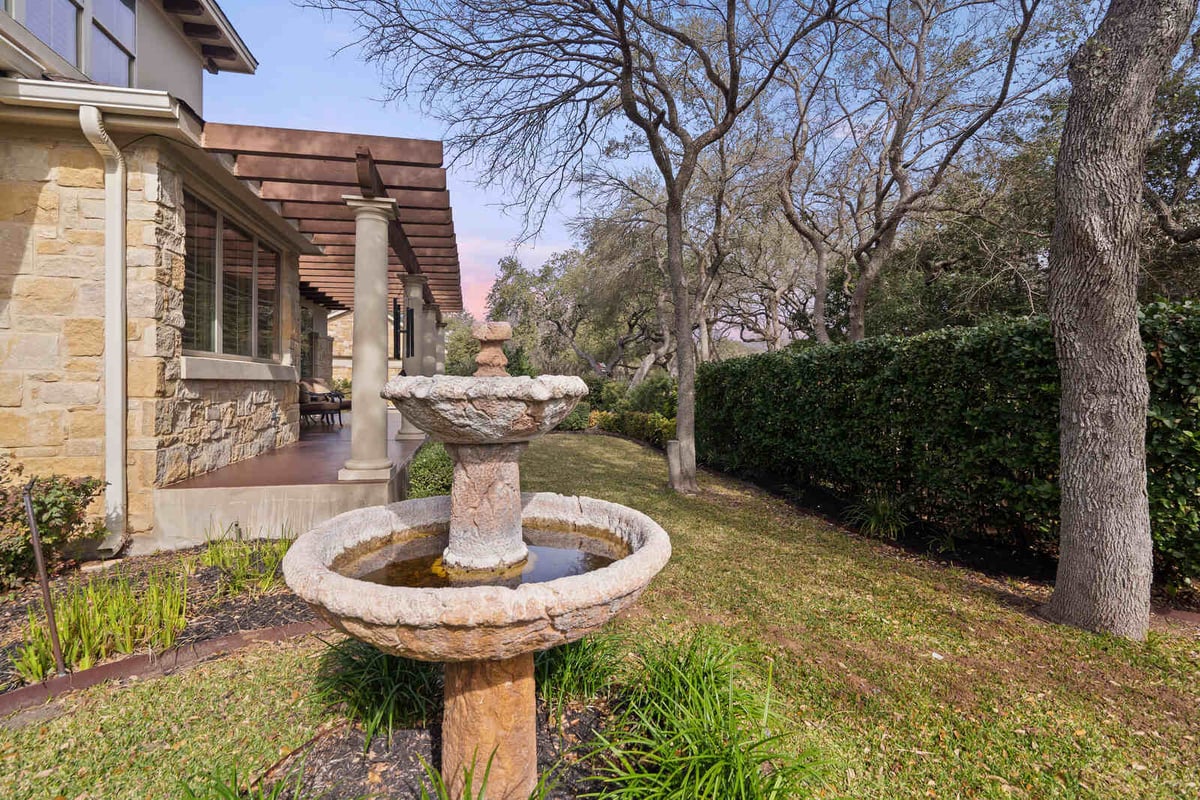 Close-up of stone water fountain in backyard of custom home by J Bryant Boyd, Georgetown TX-1