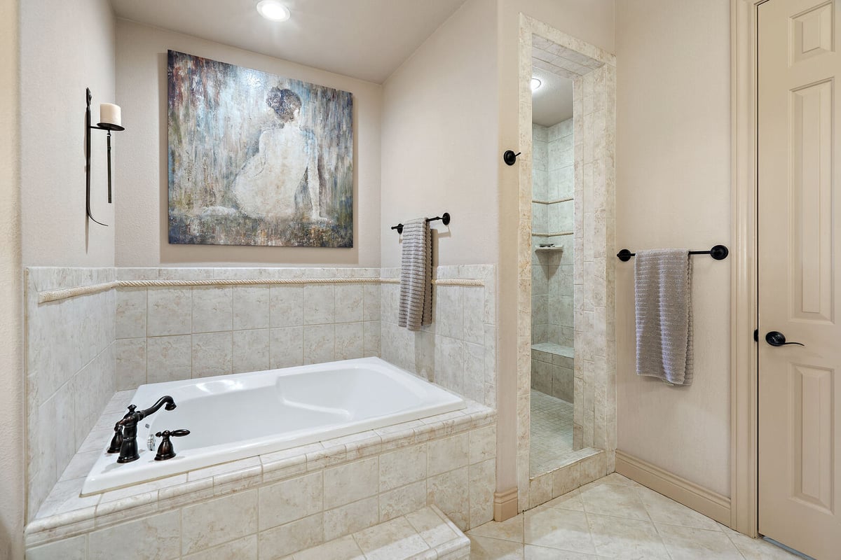 Cozy guest bedroom with ceiling fan and natural light in a Georgetown, TX custom home by J Bryant Boyd-1