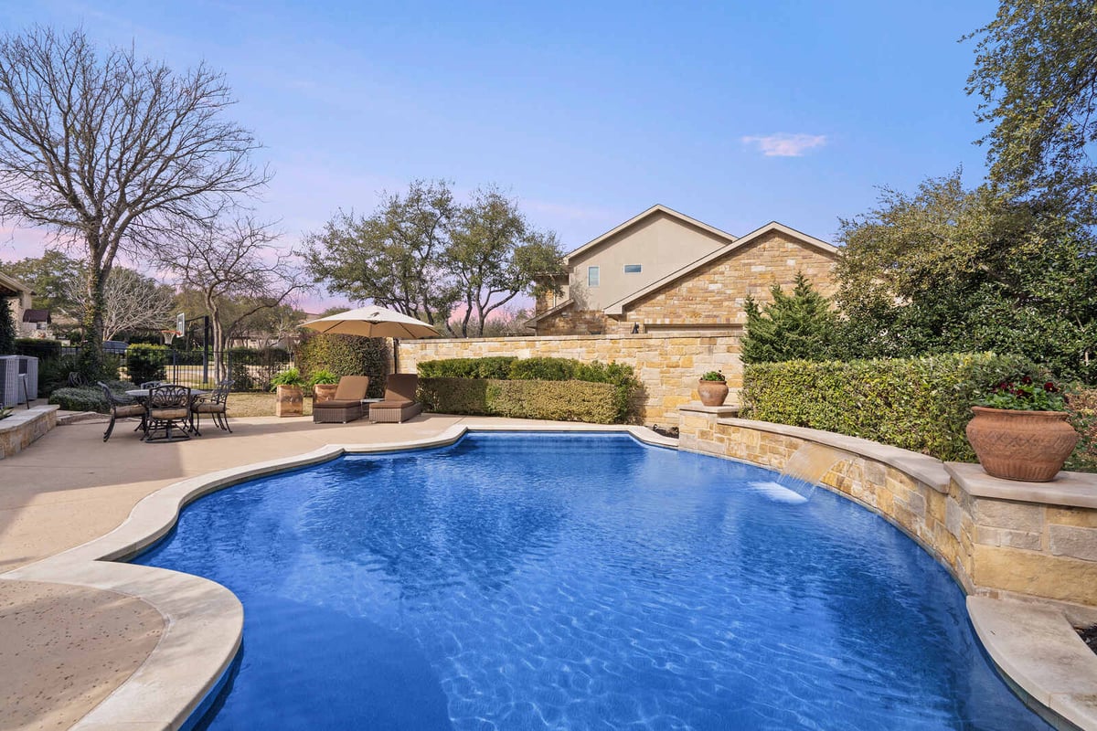 Custom home backyard pool with lounge chairs and dining area by J Bryant Boyd, Georgetown, TX