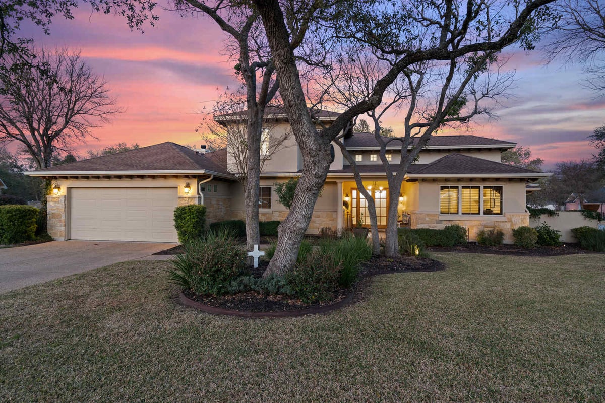 Custom stone home with a two-car garage and a well-maintained lawn in Georgetown, TX by J Bryant Boyd-1