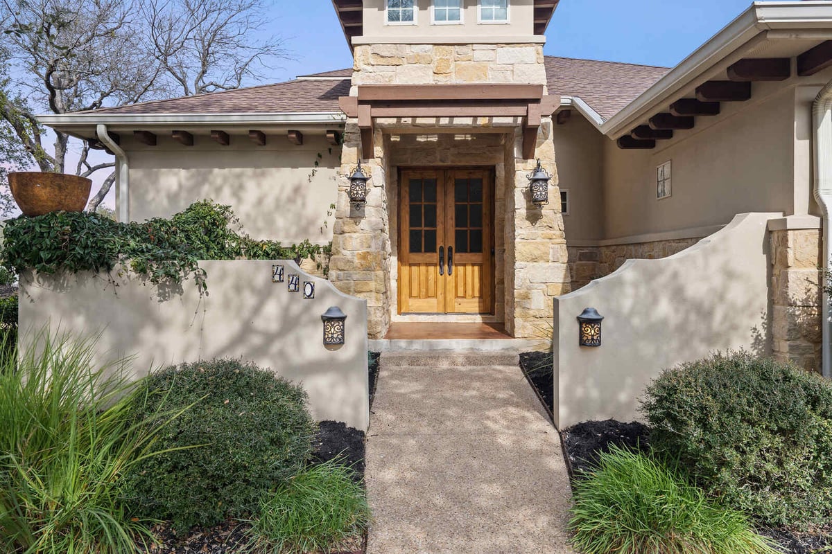 Detailed view of a custom homes front entrance with wooden doors in Georgetown, TX by J Bryant Boyd-1