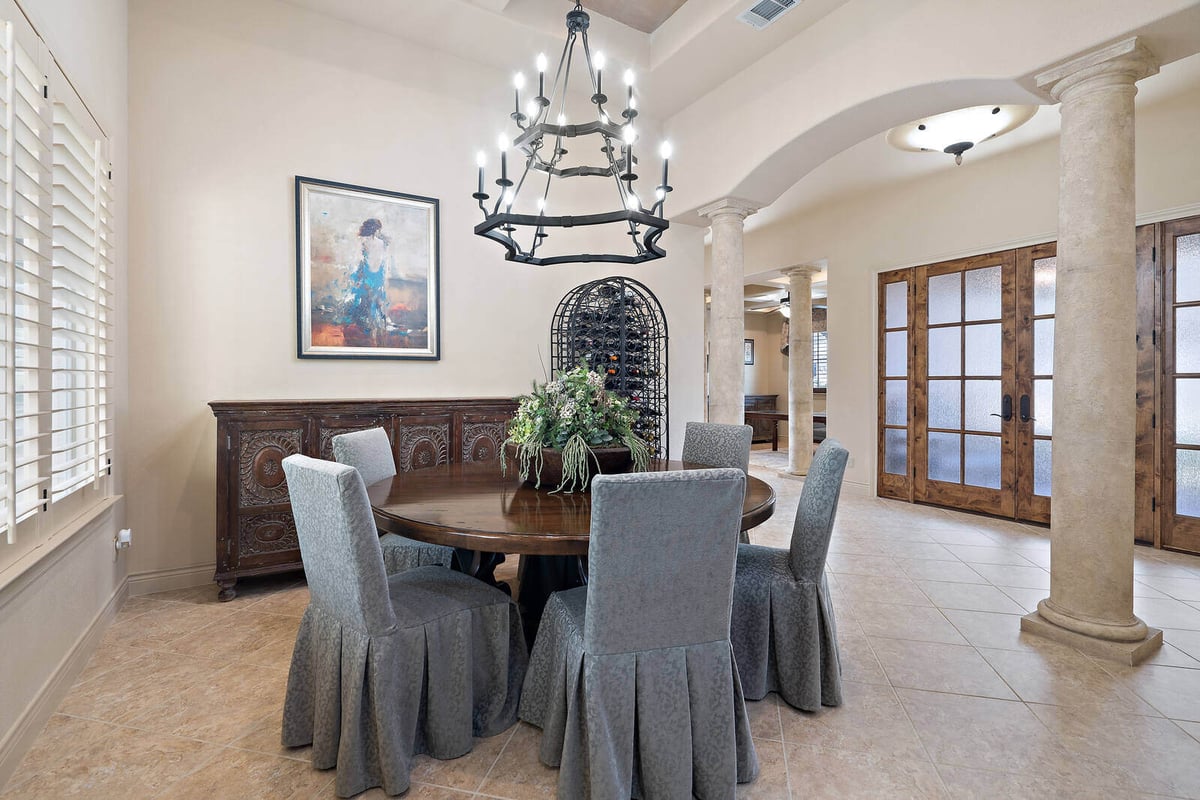 Dining room with columns and wood accents in a custom home by J Bryant Boyd in Georgetown, TX-1