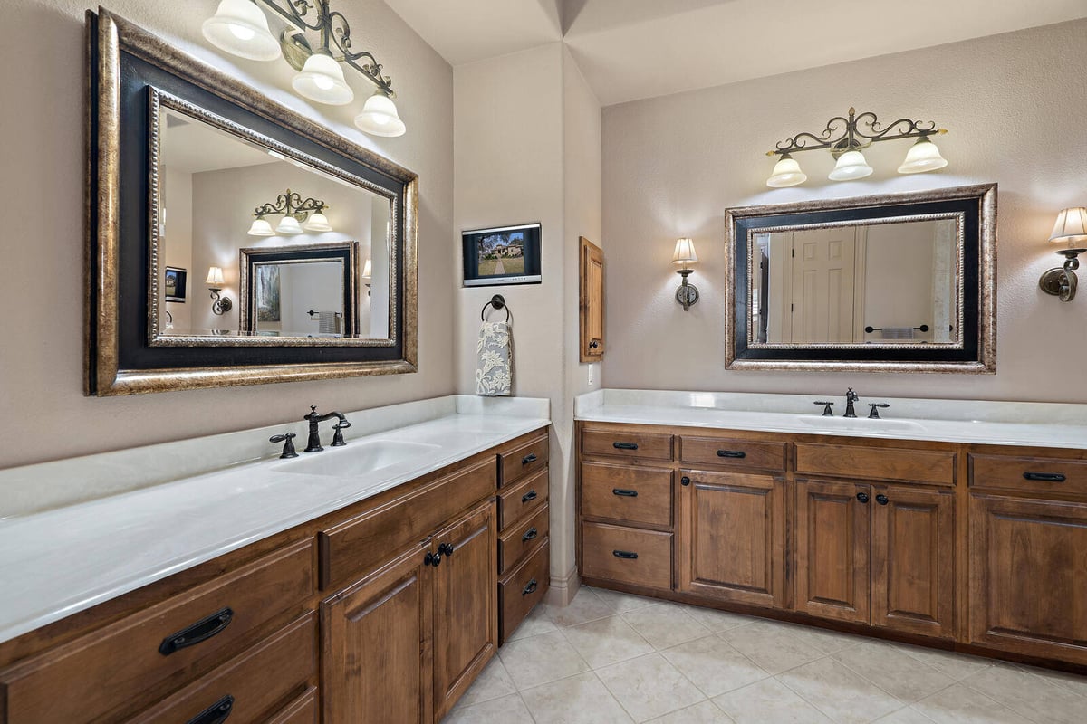 Double vanity bathroom with large framed mirrors in a Georgetown custom home by J Bryant Boyd