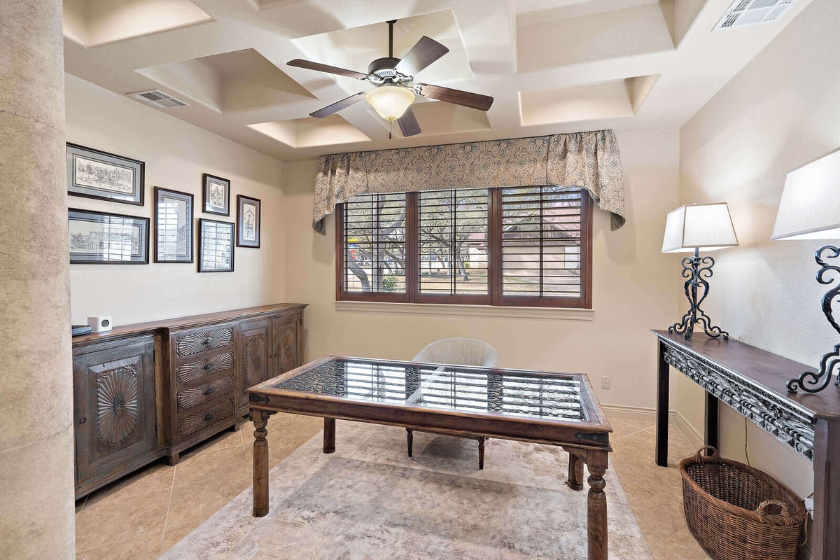 Elegant home office with wood furniture and natural light in a custom home by J Bryant Boyd in Georgetown, TX