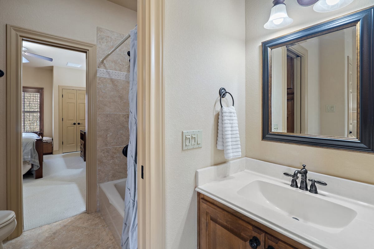 En suite bathroom with a vanity mirror and towel ring in a custom home by J Bryant Boyd, Georgetown TX-1